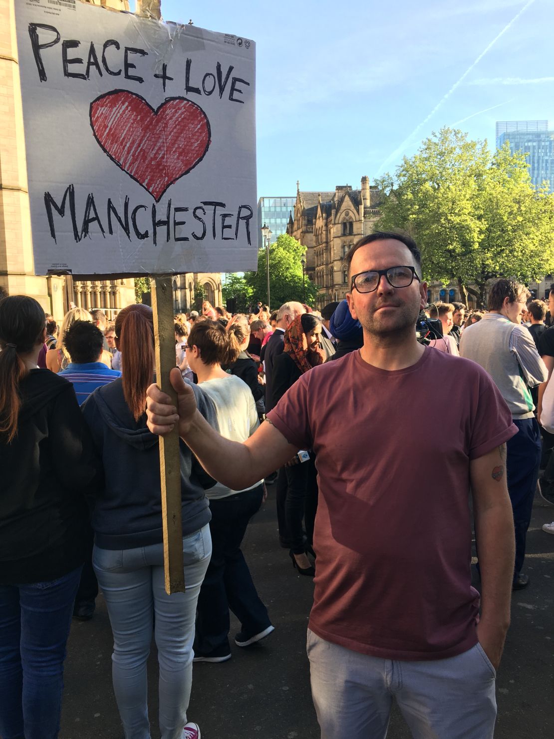 Vigil attendee John Hill made this sign which reads "Peace + Love Manchester" in support of the victims of Monday's terror attack.