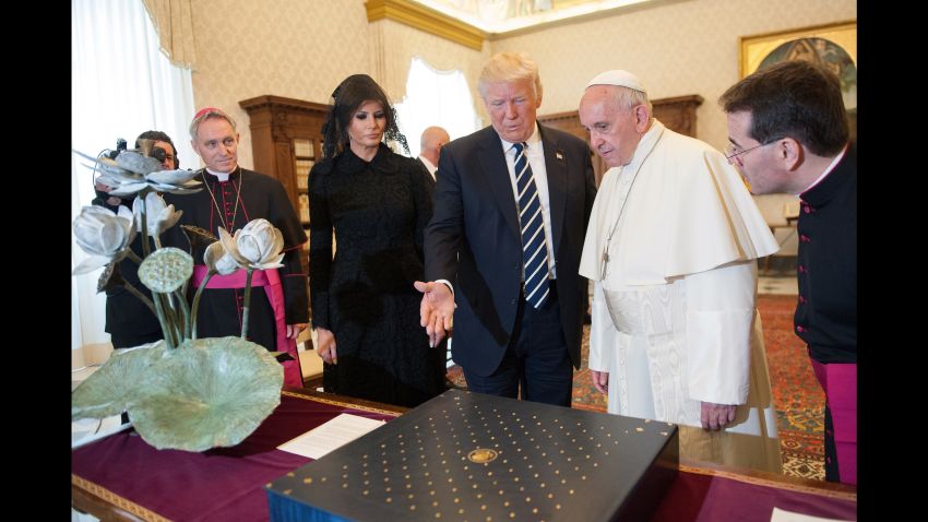 Pope Francis exchanges gifts with President Trump and Melania Trump during an audience at the Apostolic Palace in Vatican City.