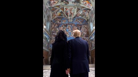 Trump and his wife look at the ceilings of the Sistine Chapel.