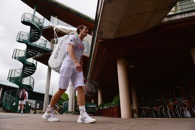 Britain's Andy Murray heads back to the locker room after finishing a practice session at Wimbledon.