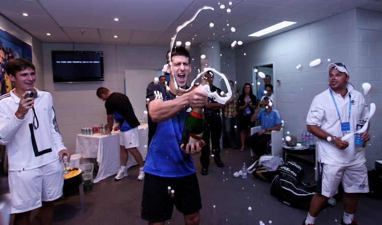 Success = champagne celebration in the dressing room. Djokovic is pictured celebrating after winning 2008 Australian Open final against Tsonga in 2008.