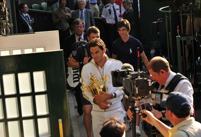 Switzerland's Roger Federer is filmed by a TV crew holding the Wimbledon trophy as he enters the dressing room after beating Andy Roddick of the US in the 2009 final. Federer has opted not to play at this year's French Open.