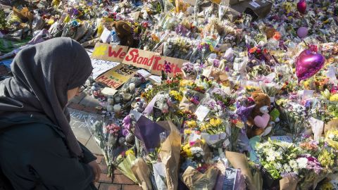 A woman looks at the floral tributes and messages left for the victims of the concert blast, during a vigil at St Ann's Square in central Manchester, England.
