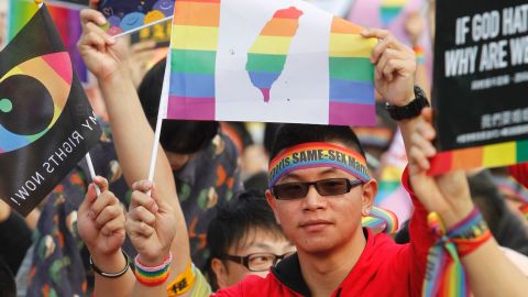 A supporter of LGBT and human rights holds a rainbow flag with Taiwan map during a rally supporting a proposal to allow same-sex marriage in Taipei, Taiwan, Saturday, Dec. 10, 2016. 