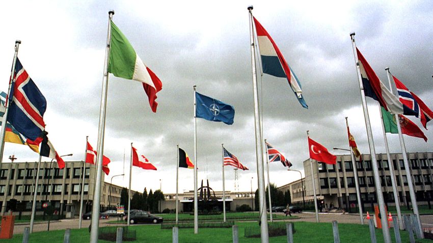 BRUSSELS, BELGIUM - OCTOBER 12:  Dark clouds hang over NATO members' flags outside the alliance's headquarters in Brussels, 12 October. The NATO allies were poised today to vote a critical "activation order" to attack Yugoslavia, as US envoy Richard Holbrooke pressed 11th-hour talks in Belgrade with a recalcitrant President Slobodan Milosevic to avert war in the Balkans.  (Photo credit should read ROBERT VANDEN BRUGGE/AFP/Getty Images)