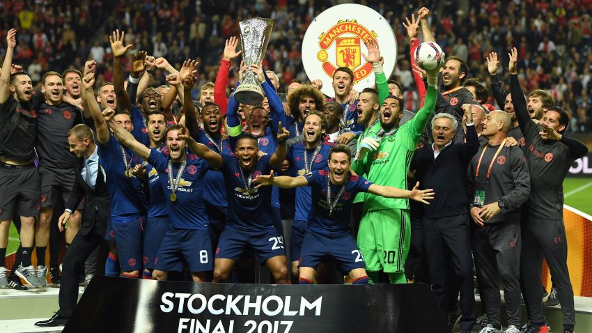 Club captain Wayne Rooney lifts trophy as United's players celebrates a first Europa League title for the club
