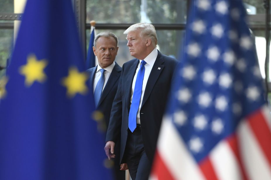 Tusk talks to Trump as he welcomes him in Brussels.