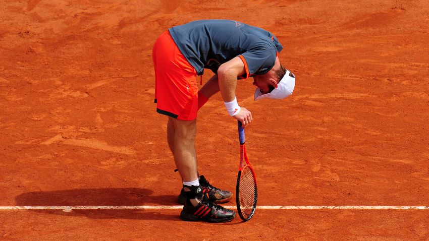 PARIS, FRANCE - MAY 31: Andy Murray of Great Britain doubles up as he struggles with a back problem during his men's singles second round match against Jarkko Nieminen of Finland during day five of the French Open at Roland Garros on May 31, 2012 in Paris, France. (Photo by Mike Hewitt/Getty Images)