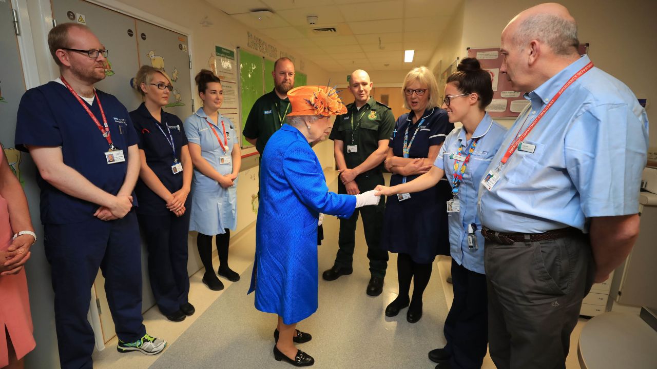 Queen Elizabeth II speaks with staff at the Royal Manchester Children's Hospital.