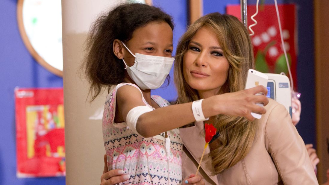 A girl takes a selfie with Melania Trump at a children's hospital in Brussels on May 25.