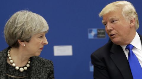 Trump speaks with British Prime Minister Theresa May during a working dinner at NATO headquarters.
