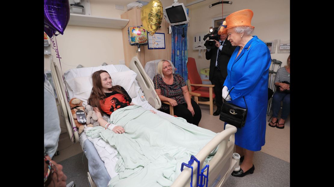 Queen Elizabeth II speaks to Millie Robson, 15, and her mother, Marie.