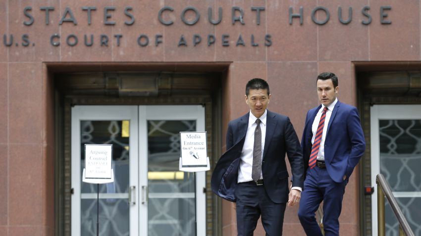 Hawaii Attorney General Doug Chin, left, walks with Joshua Wisch, right, special assistant to the attorney general, Monday, May 15, 2017, outside a federal courthouse in Seattle. A three-judge panel of the 9th U.S. Circuit Court of Appeals heard arguments Monday in Seattle over Hawaii's lawsuit challenging President Donald Trump's revised travel ban, which would suspend the nation's refugee program and temporarily bar new visas for citizens of Iran, Libya, Somalia, Sudan, Syria and Yemen. (AP Photo/Ted S. Warren)