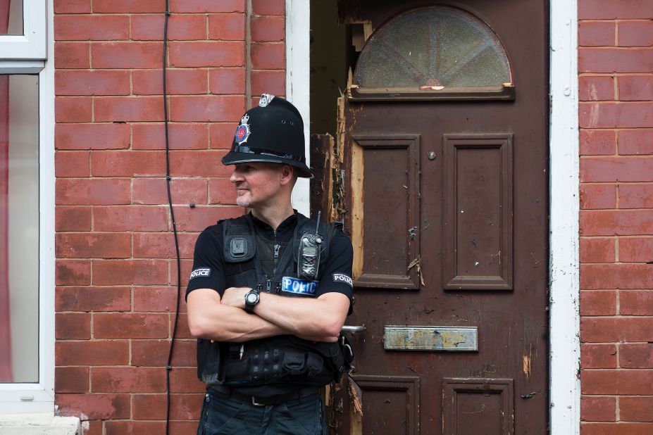 A police officer guards a house in Manchester as investigations continued on May 25. Police say a man carrying explosives <a href="http://www.cnn.com/2017/05/23/europe/manchester-terror-attack-uk/index.html" target="_blank">acted as a lone attacker</a> and died in the blast.
