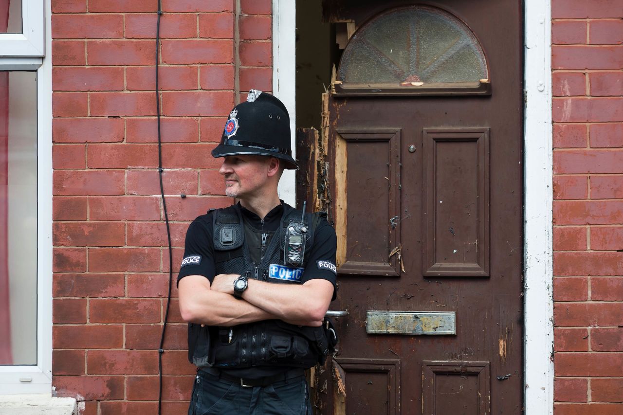 A police officer guards a house in Manchester as investigations continued on May 25. Police say a man carrying explosives <a href="http://www.cnn.com/2017/05/23/europe/manchester-terror-attack-uk/index.html" target="_blank">acted as a lone attacker</a> and died in the blast.