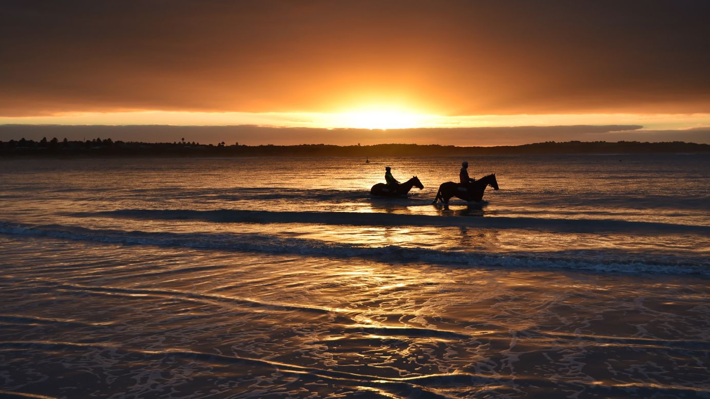 <strong>Warrnambool, Australia: </strong>Horses and riders walk on Lady Bay beach ahead of the Warrnambool Racing Carnival on May 3, 2017. 