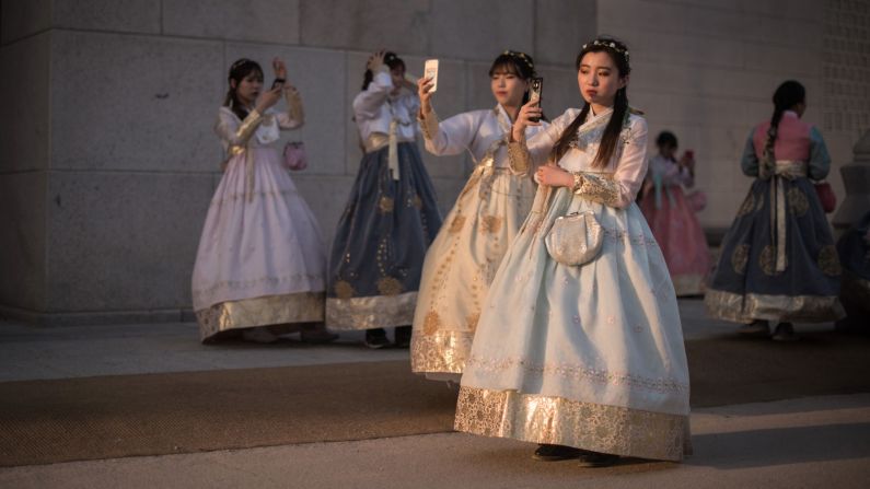 <strong>Seoul: </strong>A group of South Korean women wearing traditional hanbok dresses take selfies outside Gyeongbokgung palace in Seoul.