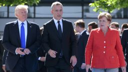 NATO Secretary General Jens Stoltenberg (C) speaks with US President Donald Trump (L) and  German Chancellor Angela Merkel (R) as they arrive for the unveiling ceremony of the Berlin Wall monument, during the NATO (North Atlantic Treaty Organization) summit at the NATO headquarters, in Brussels, on May 25, 2017. / AFP PHOTO / Emmanuel DUNAND        (Photo credit should read EMMANUEL DUNAND/AFP/Getty Images)