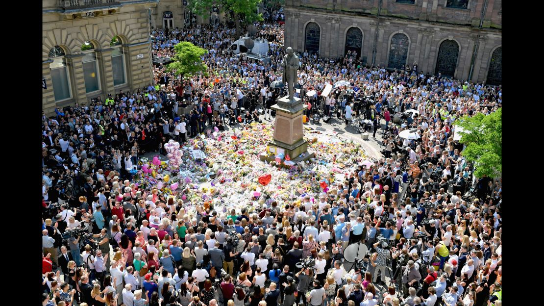 Members of the public observe a national minute's silence in remembrance of all those who lost their lives in the Manchester Arena attack, on May 25, 2017.
