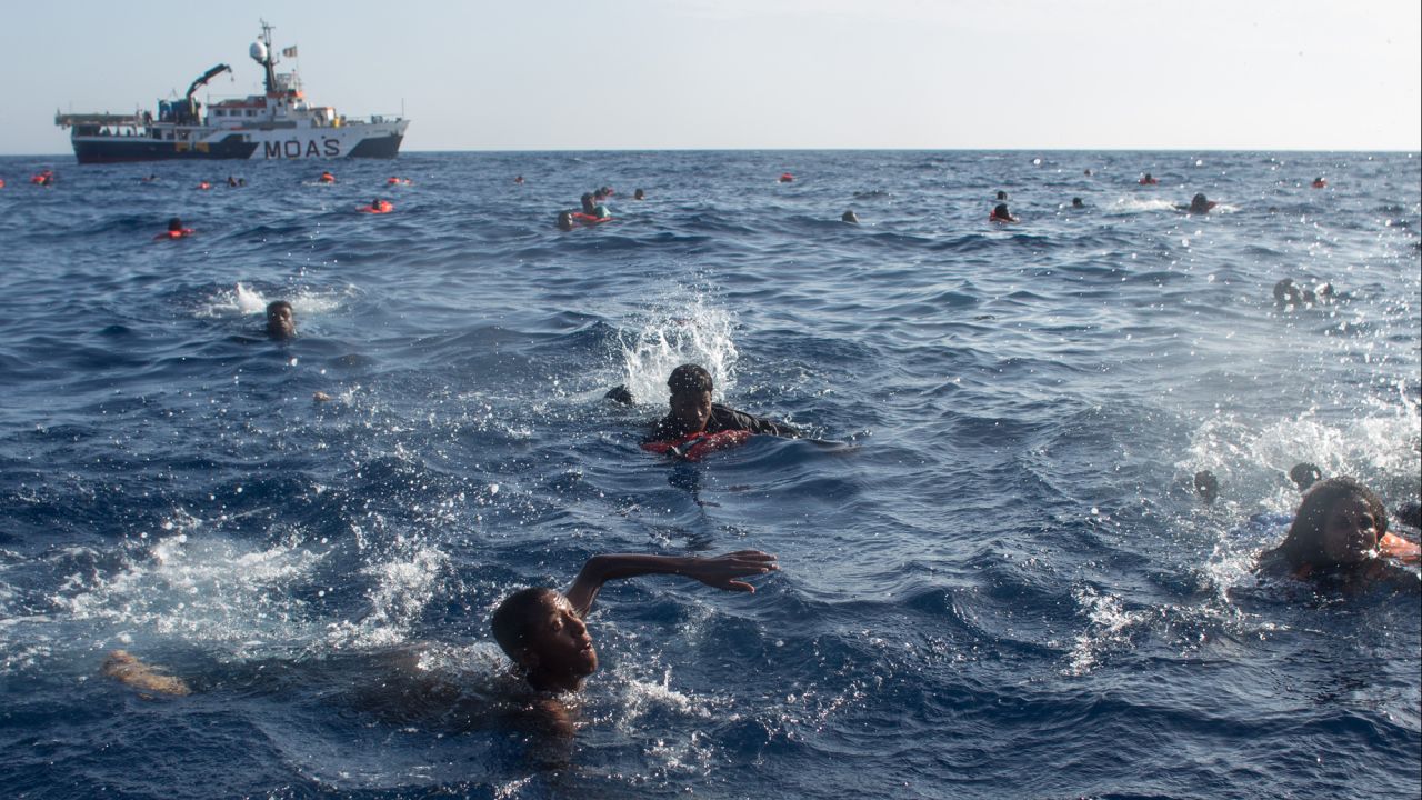Migrants swim in the Mediterranean Sea after their wooden boat capsized near the Italian island of Lampedusa on Wednesday, May 24. More than 600 people were rescued, but at least 30 people died.
