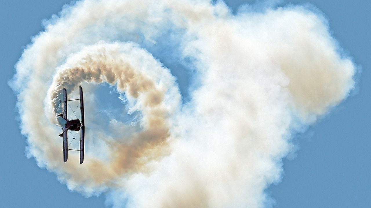 Aerobatic pilot Sean D. Tucker flies his biplane in North Kingstown, Rhode Island, on Friday, May 19. He was rehearsing for an air show over the weekend.
