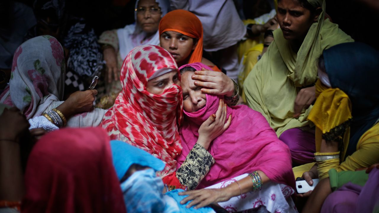 A woman comforts the mother of Shakil, a 38-year-old man who police say was killed by a gang of highway robbers near Jewar, India, on Thursday, May 25. Police say Shakil was shot after trying to save four women who were allegedly raped.