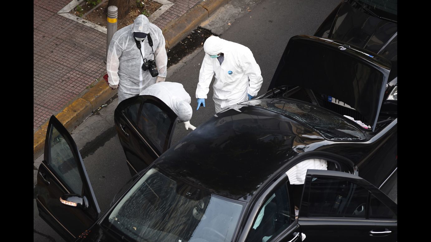 A forensics team searches for evidence in and around the car of Lucas Papademos, the former Greek prime minister who was injured Thursday, May 25, by <a href="http://www.cnn.com/2017/05/25/europe/greece-ex-prime-minister-injured-letter-bomb/" target="_blank">a letter bomb explosion</a> in Athens, Greece. Papademos opened the booby-trapped envelope as his vehicle made its way through a central Athens intersection, CNN Greece reported.