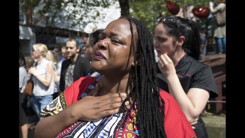 A women sheds tears after observing the minute of silence in St. Ann's Square.