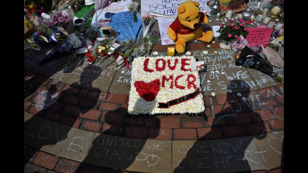 Flowers and tribute messages are left for victims in St. Ann's Square.