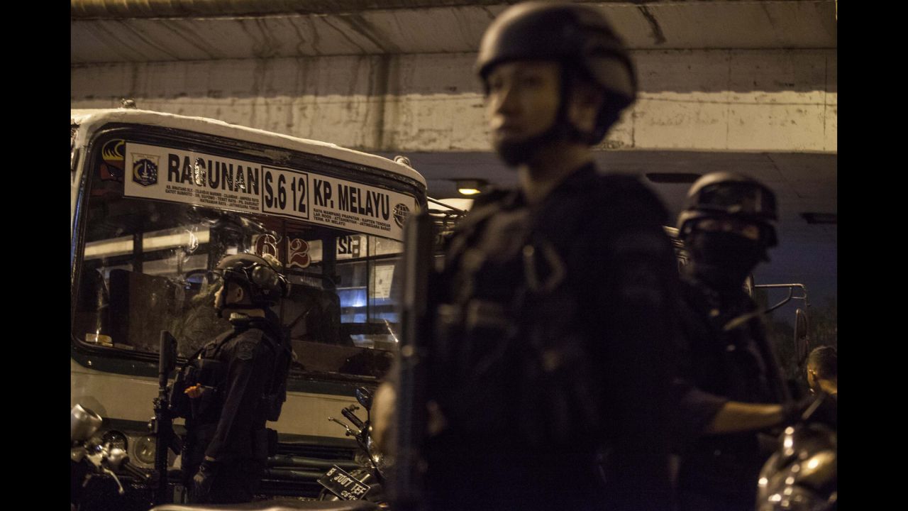 Police officers stand guard at the site of <a href="http://www.cnn.com/2017/05/24/asia/jakarta-indonesia-explosion/" target="_blank">twin bomb explosions</a> in Jakarta, Indonesia, on Wednesday, May 24. A pair of suicide bombers struck a bus station, killing at least three officers and wounding at least 11 other people.