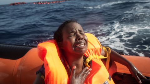 A woman cries after losing her baby in the water.