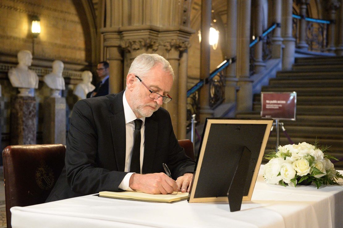 Labour leader Jeremy Corbyn signs a book of condolence at Manchester Town Hall on Tuesday.