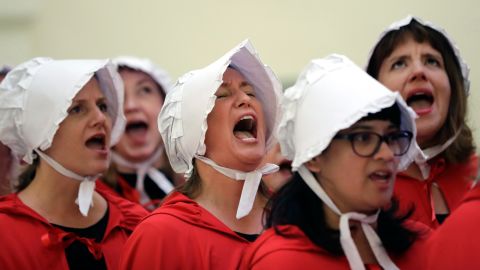 Activists dressed as characters from "The Handmaid's Tale" chant in the Texas Capitol Rotunda as they protest SB8.