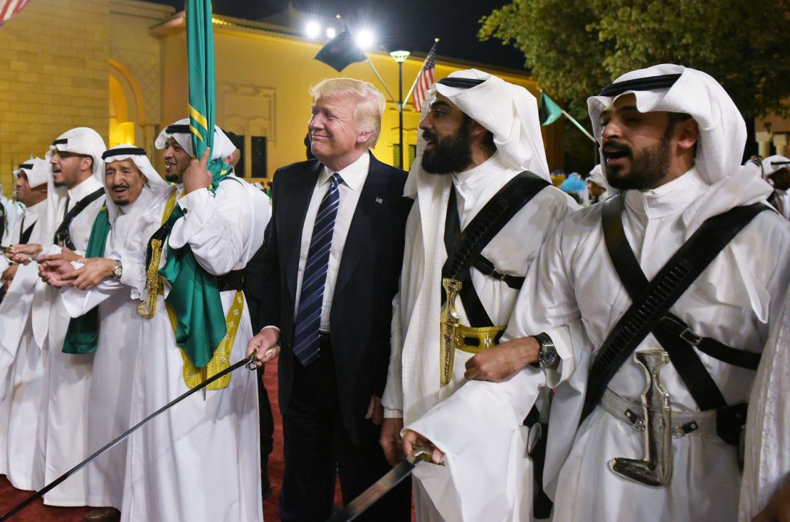 US President Donald Trump joins dancers with swords at a welcome ceremony ahead of a banquet at the Murabba Palace in Riyadh on May 20, 2017.     