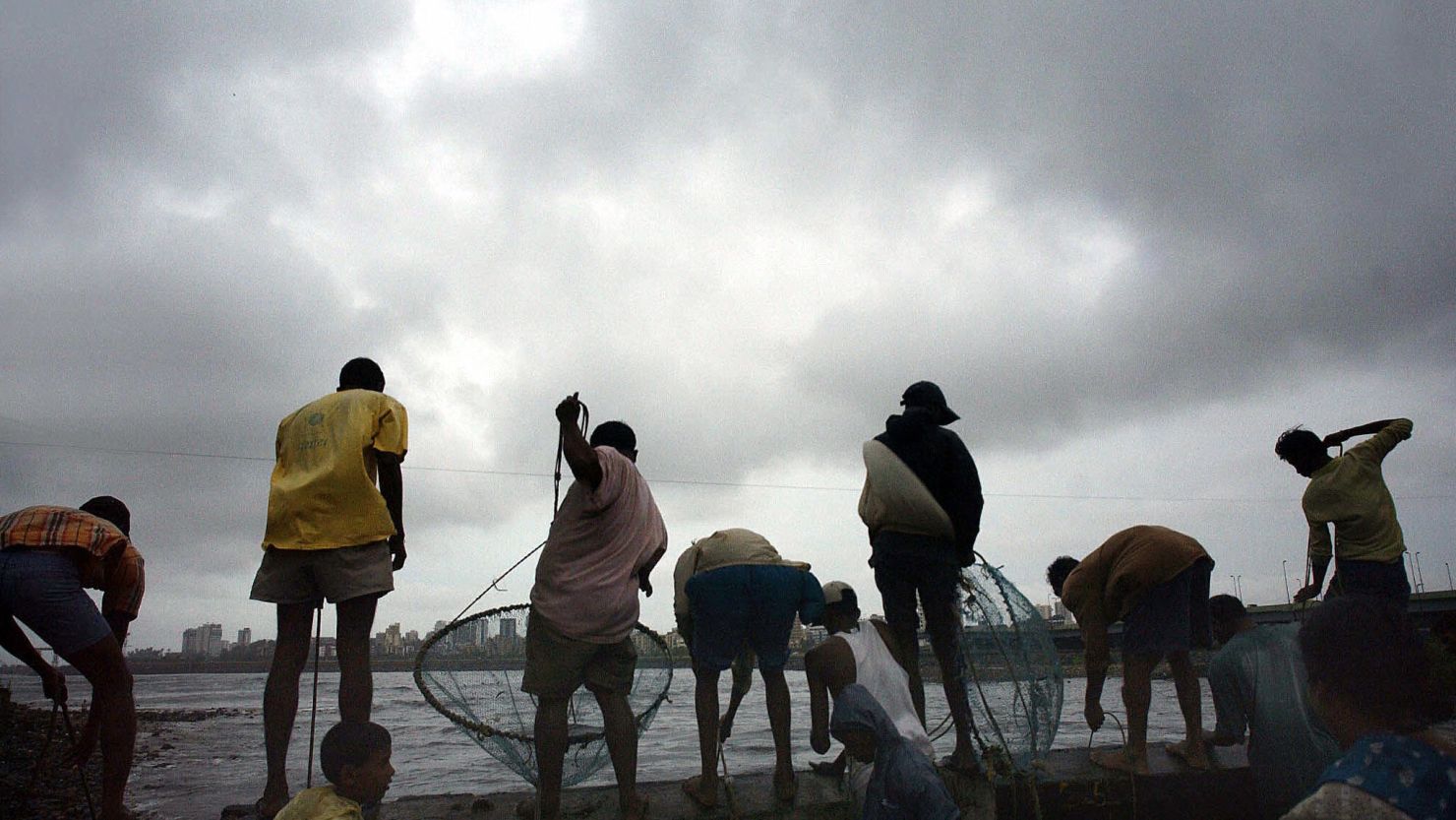 Men fish in in Mumbai.