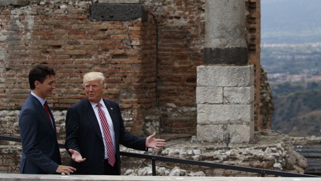 Trump and Trudeau walk together after the group photo.