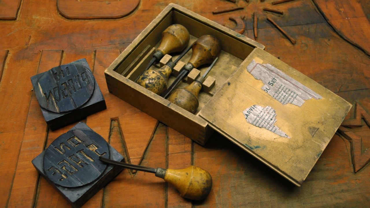 Imagery is carved by hand into blocks that are used in the printing process.