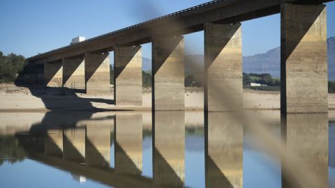 A truck crosses a bridge on May 10 at Theewaterskloof Dam. Bridge supports show previous high water marks. 