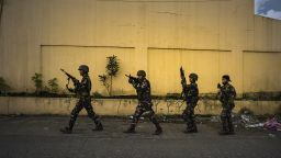 MARAWI CITY, PHILIPPINES - MAY 25: Soldiers take positions while evading sniper fire as they try to clear the city of armed militants one street at a time, on May 25, 2017 in Marawi city, southern Philippines. Gun battles between ISIS-linked militants and Filipino troops erupted in Marawi city on Tuesday when gunmen from the local terrorist groups Maute Group and Abu Sayyaf rampaged through the southern city, prompting President Rodrigo Duterte to declare 60 days of martial law in Mindanao. Thousands of residents were reported to have fled from Malawi city while at least 21 people were killed, including a police chief who had been beheaded and buildings were torched by the terror groups. President Duterte said the influence of Islamic State is one of the nation's top security concerns, and martial law on Mindanao island could be extended across the Philippines to enforce order, allowing the detention of people without charge. (Photo by Jes Aznar/Getty Images)