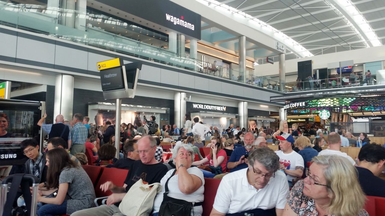 Passengers wait Saturday at London's Heathrow Airport as British Airways experiences computer problems.