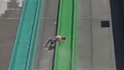 Boy falls off water slide