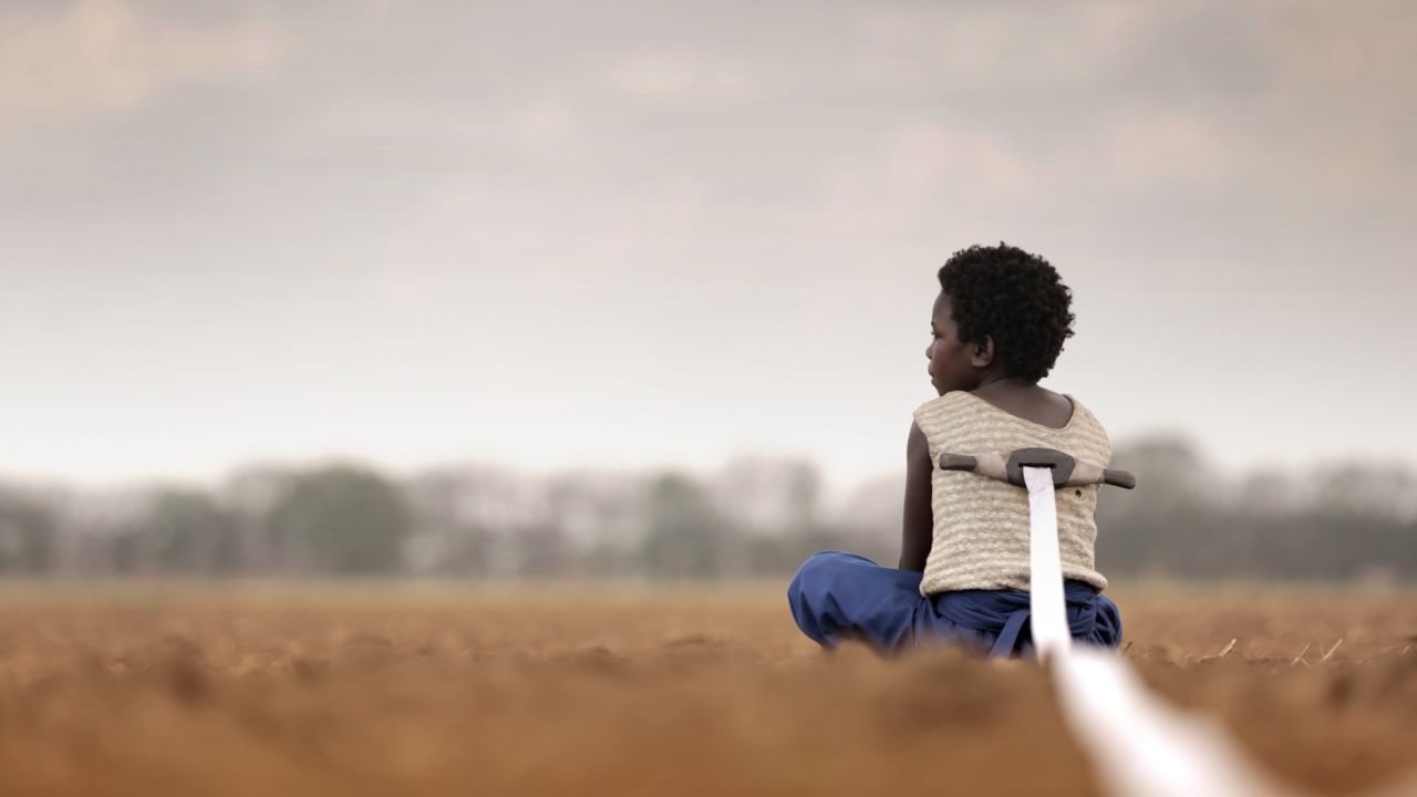 Nine-year-old Shula (Mulubwa) is told if she cuts the ribbon attached to her back, she'll be turned into a goat.