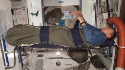 An astronaut sleeps aboard the International Space Station.