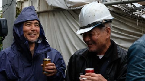 Yuichi Aoki (left) takes a break from demolishing a house in Saitama, Japan.