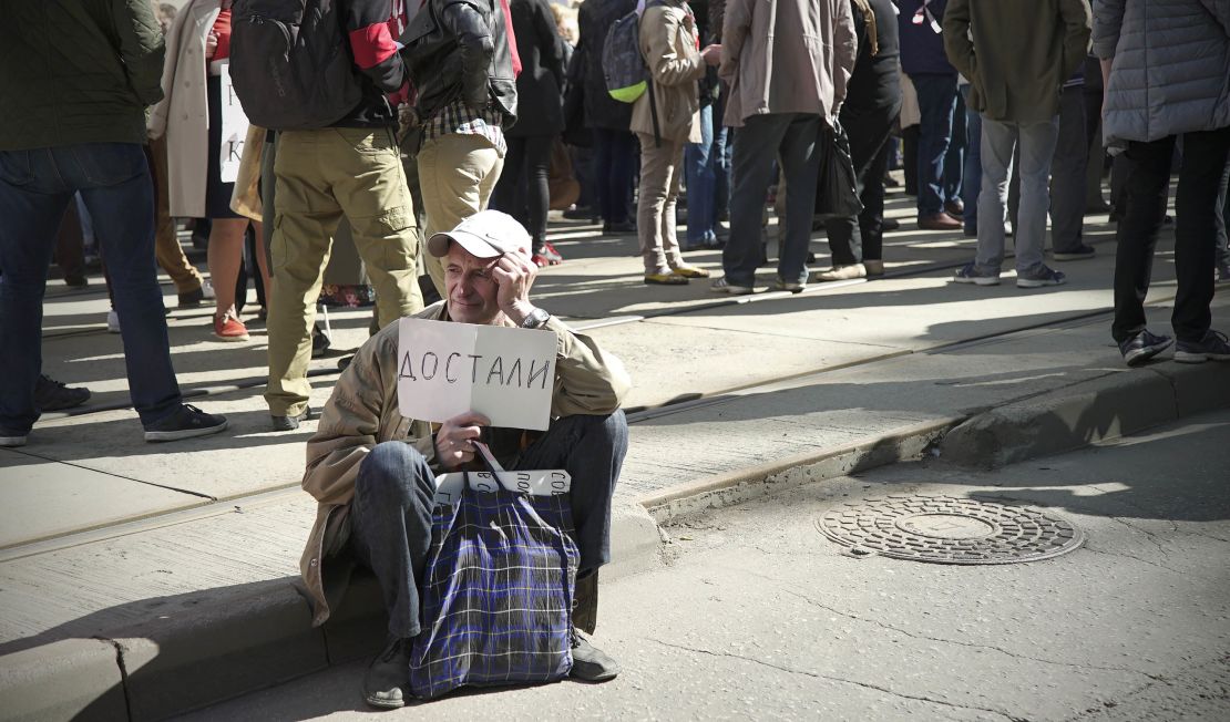 A man carries a placard which reads: "Fed Up."