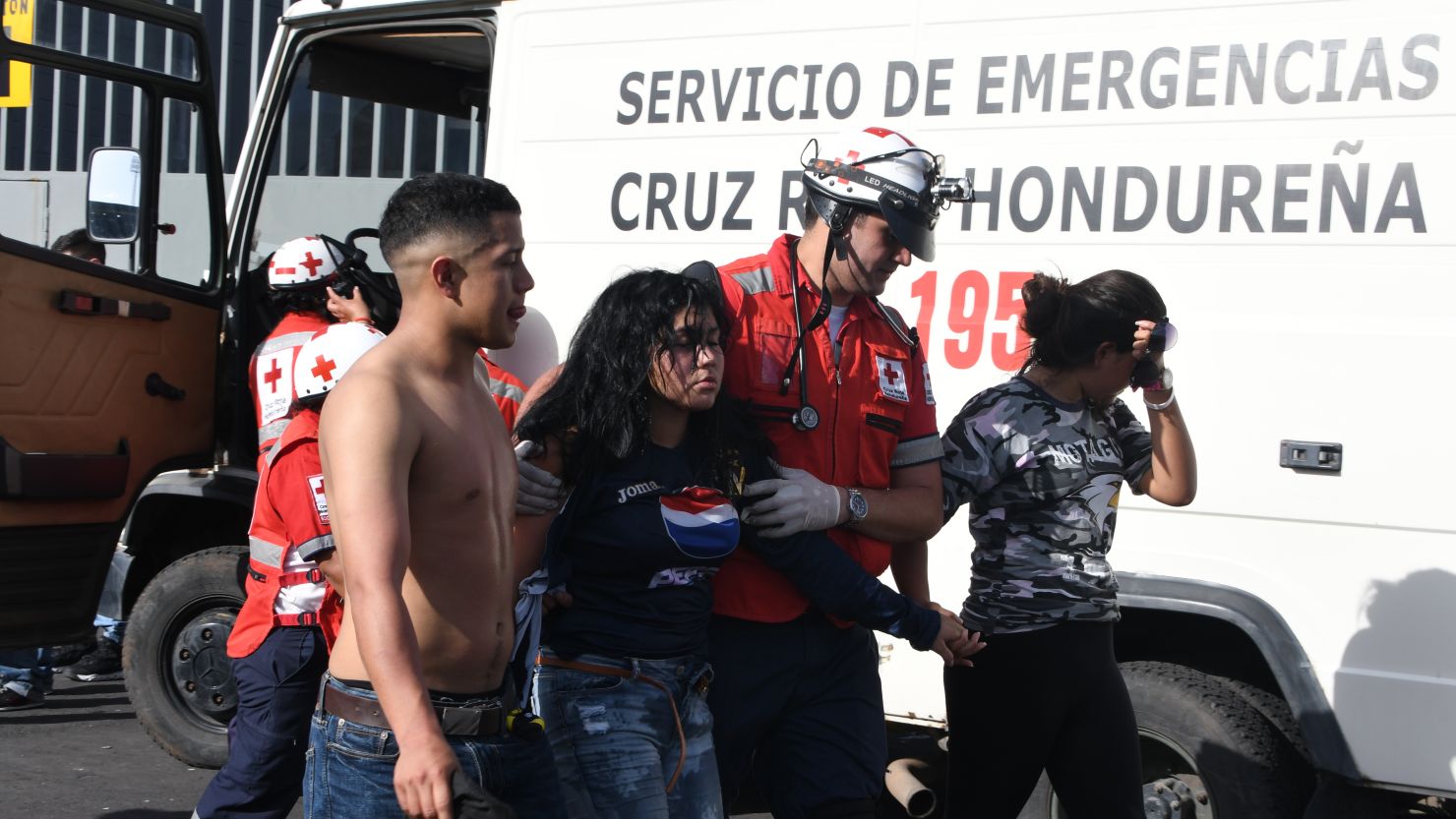 An injured fan is helped away by emergency services following a stampede at the national stadium in Honduras.