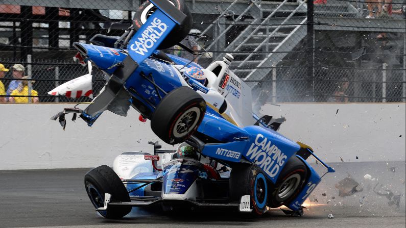 Scott Dixon's car goes over Jay Howard's during a crash at <a href="index.php?page=&url=http%3A%2F%2Fwww.cnn.com%2F2017%2F05%2F28%2Fsport%2Findianapolis-500%2F" target="_blank">the Indianapolis 500</a> on Sunday, May 28. Howard had clipped the wall and bounced into Dixon, sending him airborne with flames firing out the back of the car. Neither driver was injured.