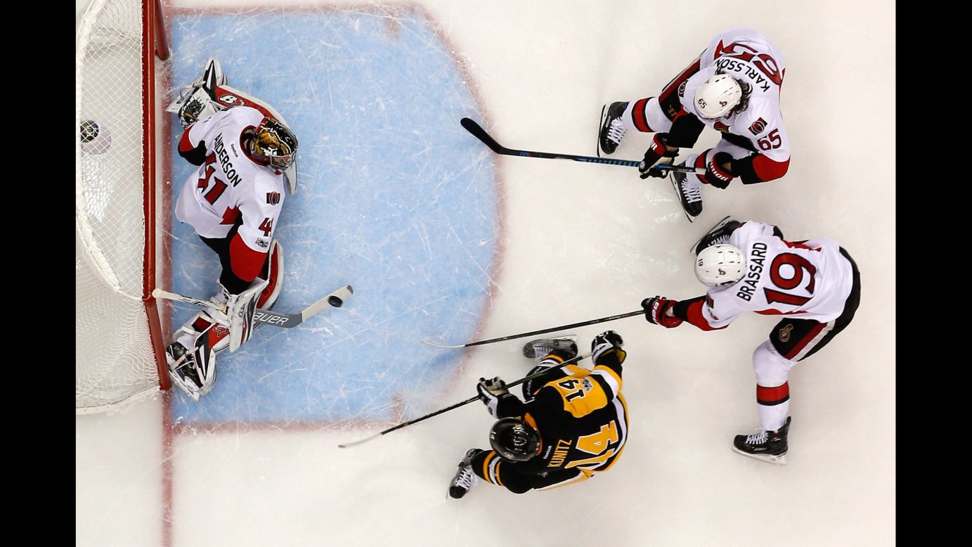 Pittsburgh's Chris Kunitz, bottom, scores a goal against Ottawa during Game 7 of the NHL's Eastern Conference Final on Thursday, May 25. Kunitz also scored the game-winning goal in double overtime. 