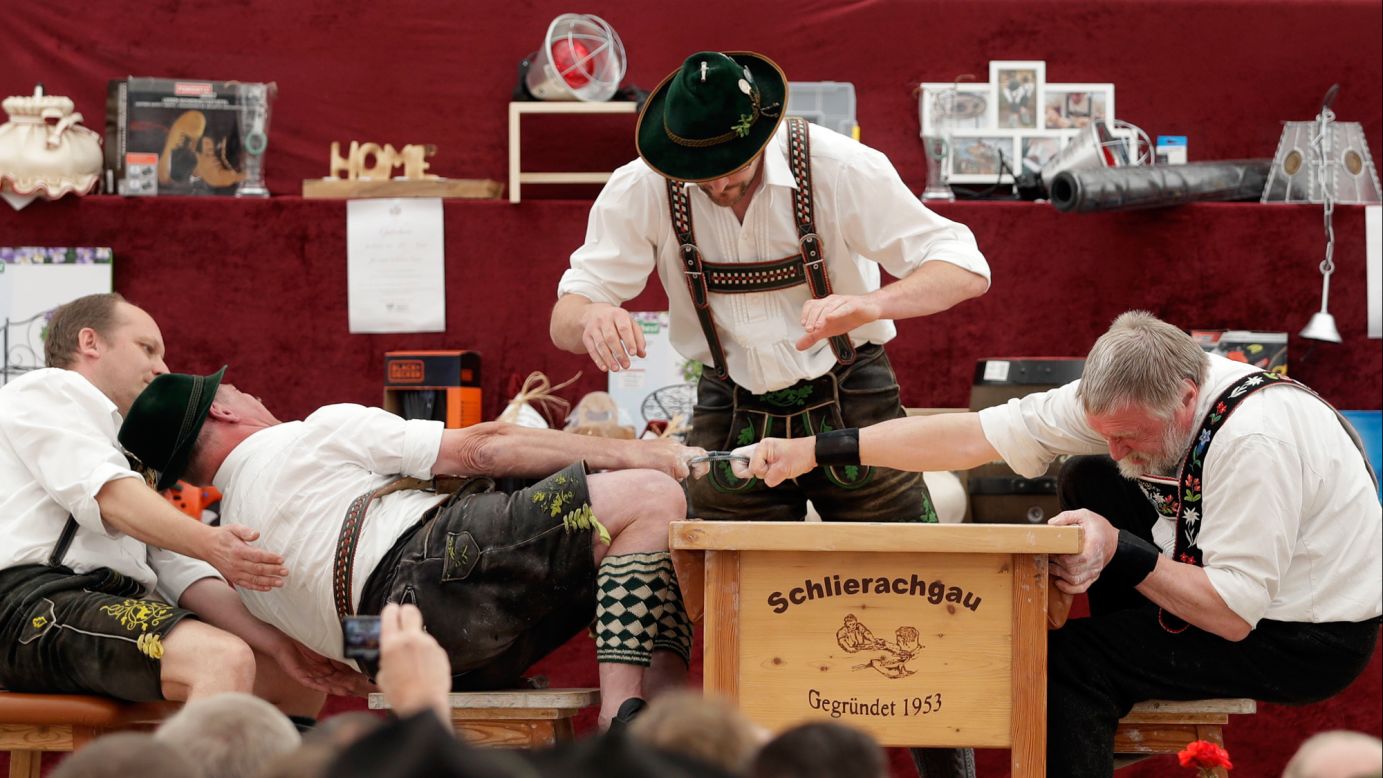 A man tries to pull his opponent over the table during a finger-wrestling match Thursday, May 25, at the Alpine Country Championships in Wornsmuhl, Germany.