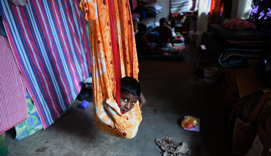 A young Sri Lankan flood victim rests at a relief camp after being evacuated following flooding in the suburb of Kaduwela in the capital Colombo.
